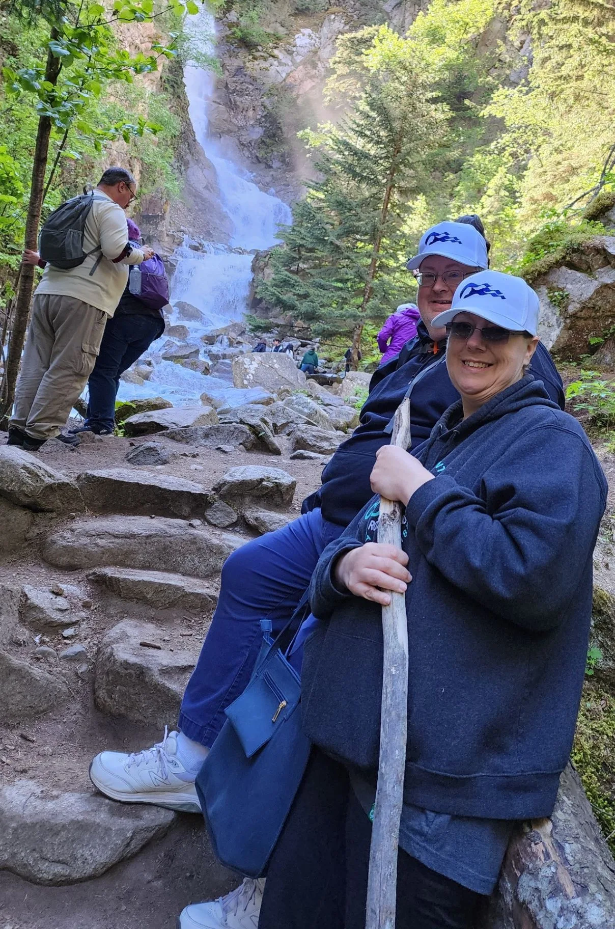 Tonya and Dean Becker in Alaska with a waterfall behind them